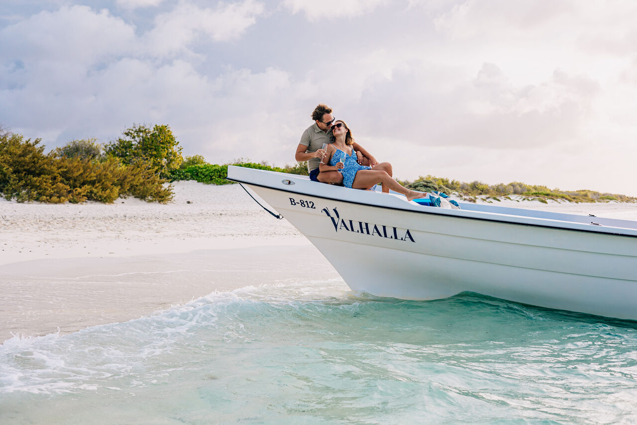 The boat anchored at a sandy Bonaire shore